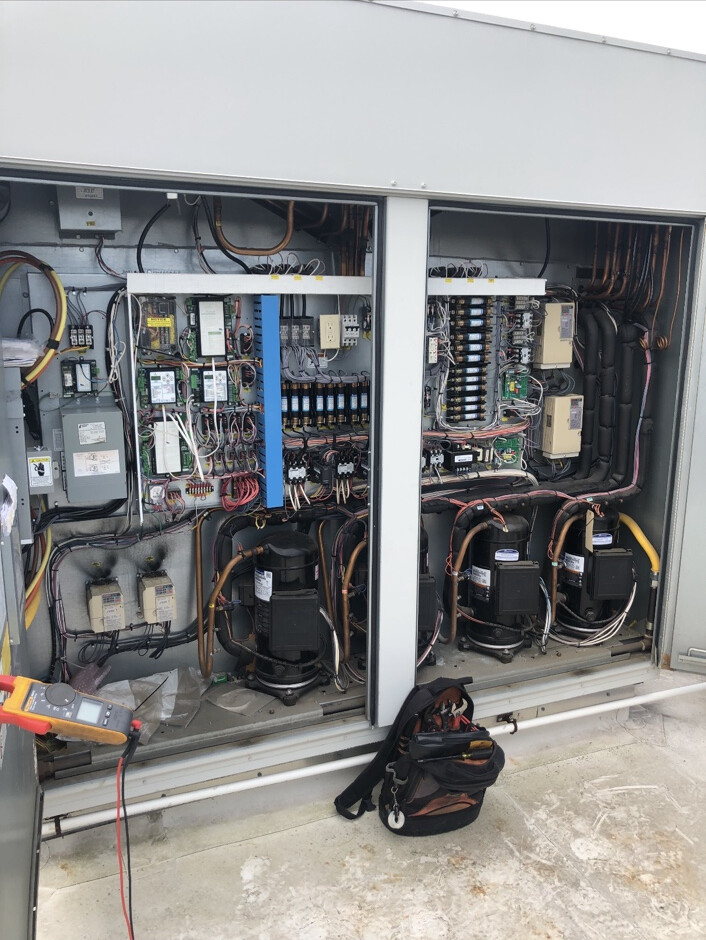 Open multi-circuit commercial rooftop HVAC equipment during service diagnostics